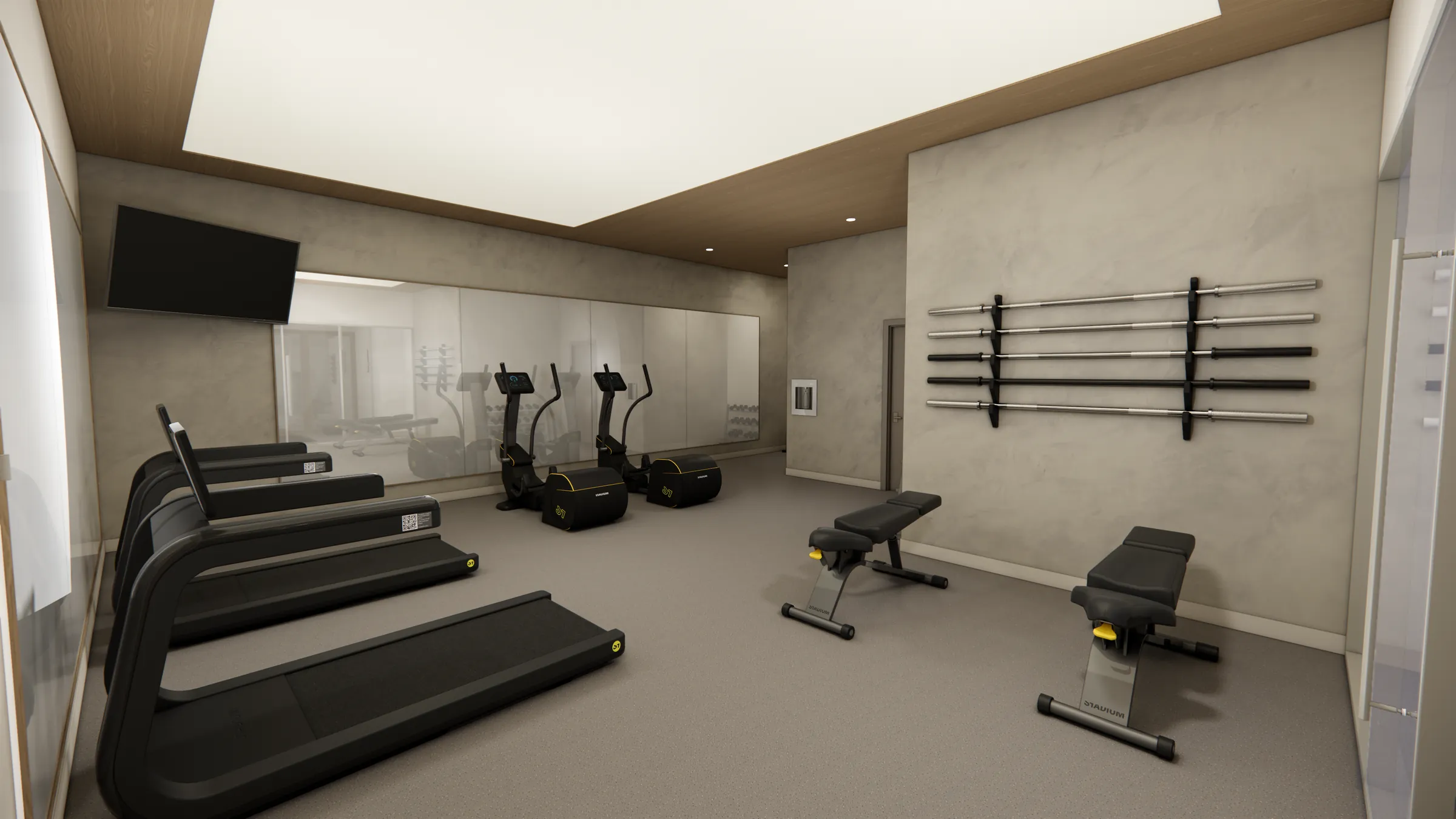 Indoor fitness floor with treadmills and Olympic bar wall at Serenity Kelowna